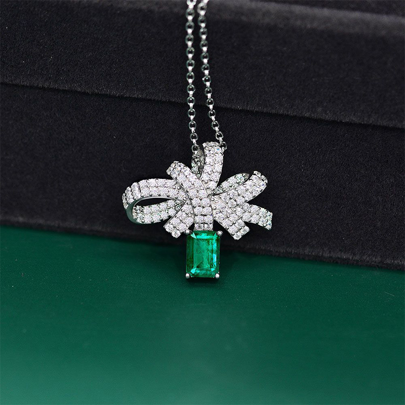 Micro Paved Bowknot with Green Emerald Cut Pendant in Sterling Silver